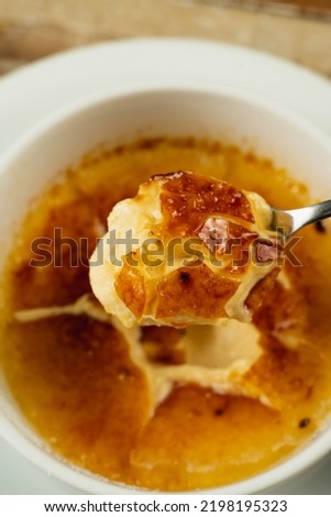 Similar – Image, Stock Photo Creme brulee with caramel crust. Burning sugar on burnt cream