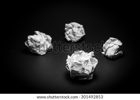 Crumpled paper on black background. Business frustrations, Job stress and Failed exam concept. Black and White filter.
