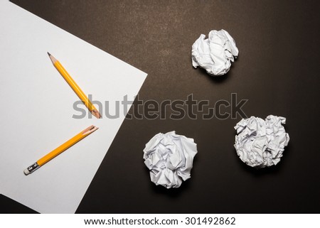 Broken pencil, paper, crumpled paper on black background. Business frustrations, Job stress and Failed exam concept.  Shot at above.