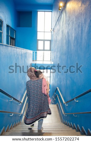 Similar – Image, Stock Photo Muslim mother embraced slept little girl in front of blue wall background