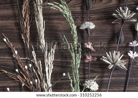 Mix of paper rice and paper flower on wood table