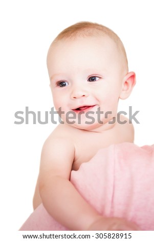 An adorable baby boy being held on a white background.