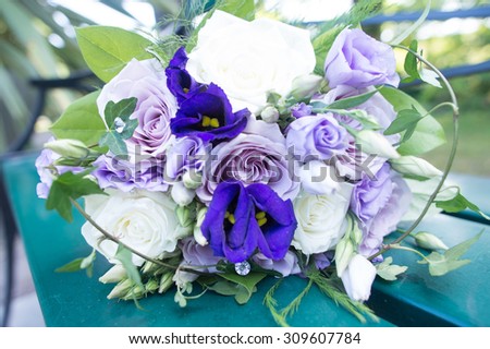 Wonderful wedding bouquet with purple, blue and white flowers