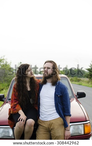 Young couple sitting on their pickup truck