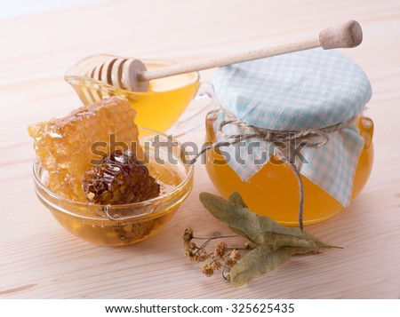 Linden honey and honeycomb with linden flowers.