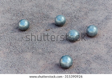 Petanque ball boules bawls on a dust floor