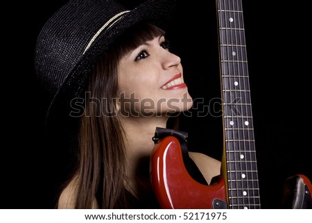 Female country singer holding a red guitar
