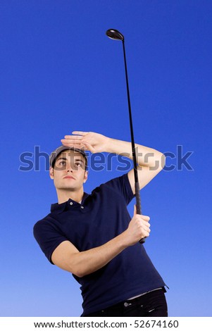 Golf player looking after the ball after a long drive