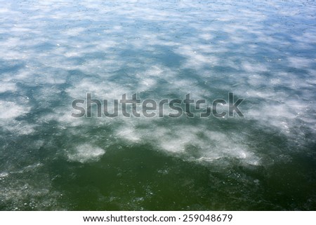 A close angle view of patches of ice floating in Penobscot Bay, Searsport, Maine, Atlantic Ocean.