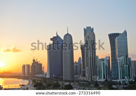 Sunset over the skyscrapers in the skyline of the commercial center of Doha, the capital of the Arabian Gulf state Qatar.