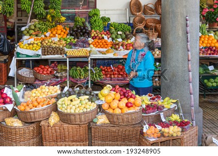 FUNCHAL, PORTUGAL - MAY 06: Elderly woman selling vegetables at the market of the famous Mercado dos Lavradores on May 06, 2014 at Funchal, capital city of Madeira, Portugal