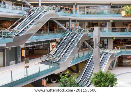 AMSTERDAM, THE NETHERLANDS - MAY 23: People shopping in the Dutch indoor shopping mall Villa Arena with escalators on May 23, 2014 in Amsterdam, the Netherlands