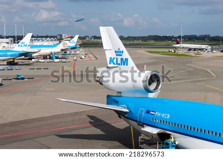 AMSTERDAM, THE NETHERLANDS - SEP 11: Schiphol airport with workers and departing and arriving airplanes on September 11, 2014 at Amsterdam, the Netherlands