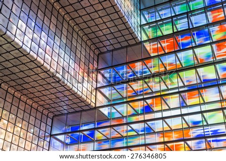 HILVERSUM, THE NETHERLANDS - MARCH 03: Modern interior Dutch institute Sound and Vision with huge colorful glass wall on March 03, 2015 in Hilversum, The Netherlands