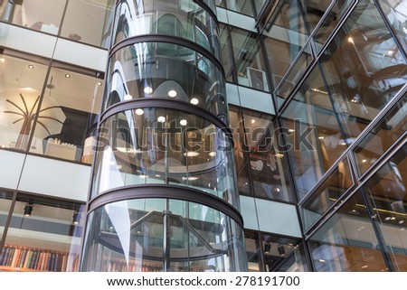 HAMBURG - APRIL 25: Glass elevator with unknown people in shopping mall \'Europassage\' on April 25, 2013 in Hamburg, Germany