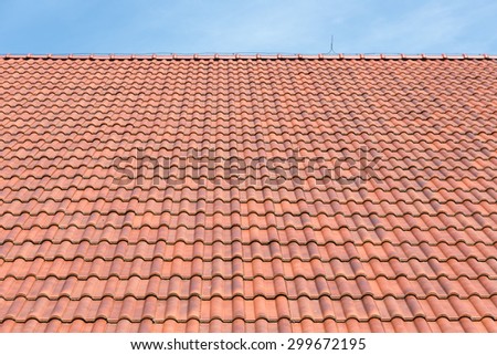 Red tiles roof background with blue sky