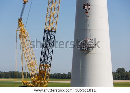 URK, THE NETHERLANDS - AUG 07: Dutch workers busy with the construction of a big new wind turbine on August 07, 2015 near Urk, the Netherlands