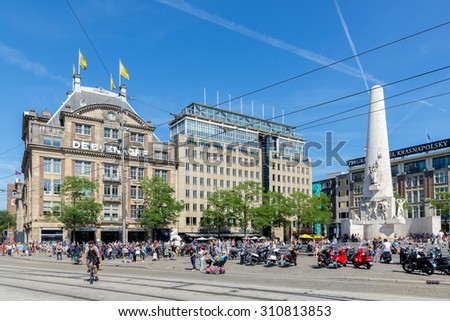 AMSTERDAM, THE NETHERLANDS - AUG 06: People near the Dutch National War Memorial at central plaza De Dam on August 06, 2015 in Amsterdam, the Netherlands