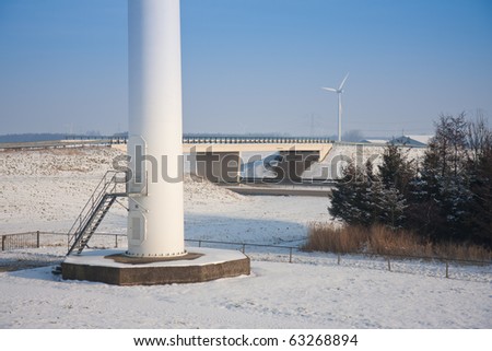 Foundation of a big windmill near a motorway in a snowy landscape of the Netherlands