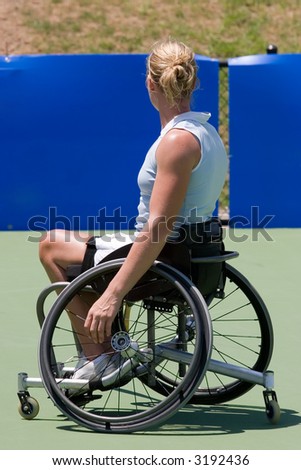 A wheelchair bound athlete on the tennis court