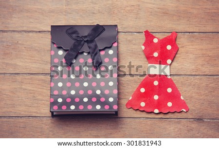 Paper clothes on the wooden background