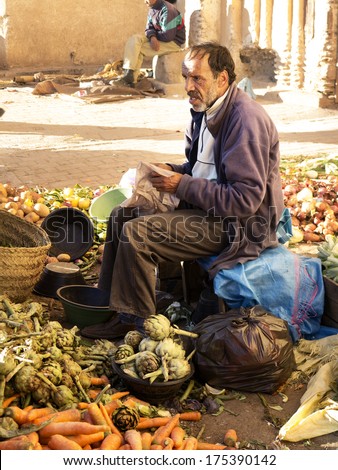 FEZ,MOROCCO - FEBRUARY 05:moroccan man selling vegetables and fruits in the souk of Fes on February 5,2013.Vegetables are important ingredients in the moroccan diet.