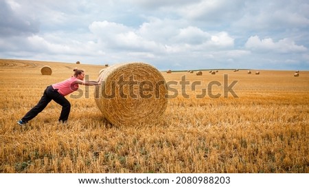 Similar – Image, Stock Photo Woman Pushing Hay Bale