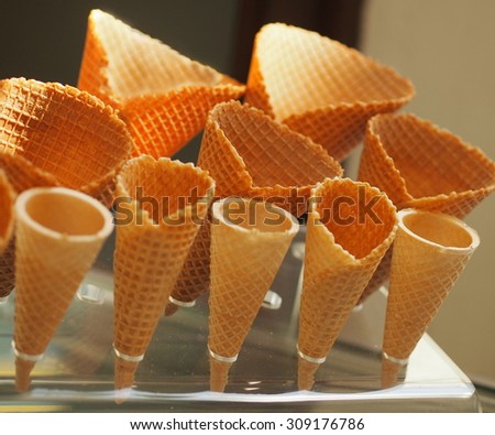 Several ice cream cones in a plastic stand.
