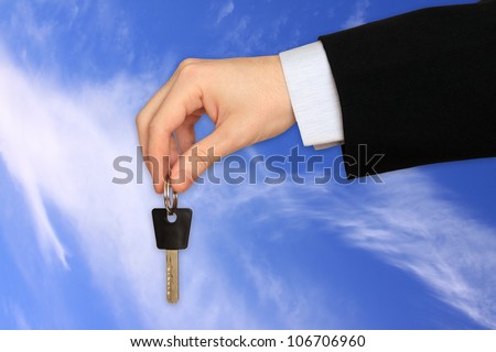 The Key to Success in the Hand on the cloudy Sky