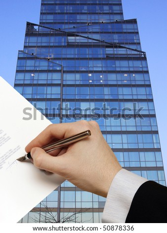 The Signature of Business Contract in front the Skyscraper on the blue Sky