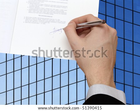 The Signature of Business Contract in front the Skyscraper