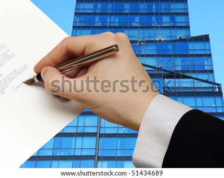 The Signature of Business Contract in front of the Skyscraper
