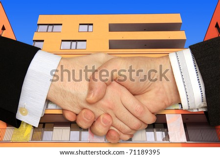 Businessmen shaking hands in front of the Modern Building
