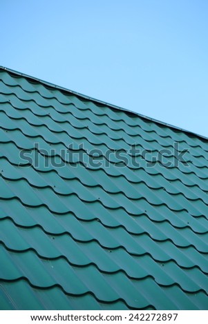 Modern metal tile roofing against a blue sky
