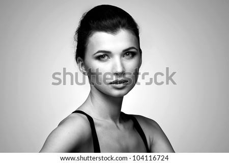 Black and white portrait of fashion woman in black dress on natural background