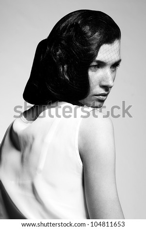 Black and white portrait of fashion woman with professional makeup and hairstyle on white background