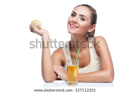 Portrait of happy young woman with glass of apple juice on white background. Concept vegetarian dieting - healthy food