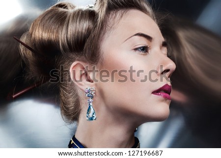 Glamour portrait of beautiful fashion model posing in exclusive jewelry. Professional makeup and hairstyle