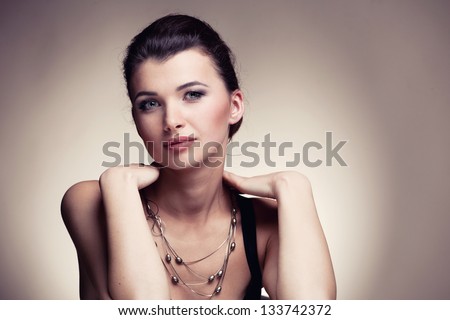 Portrait of luxury woman in exclusive jewelry on natural background