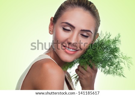 Close-up portrait of happy young woman with  bundle herbs (dill) in hands.  Concept vegetarian dieting - healthy food