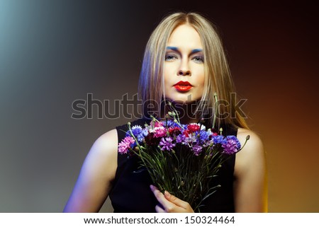 Beauty woman with bunch flowers. Professional Makeup and hairstyle
