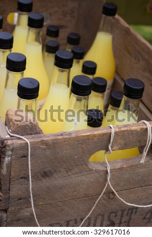 Wooden box with apple juice bottles