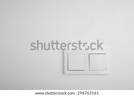Double wall switch on the white wall