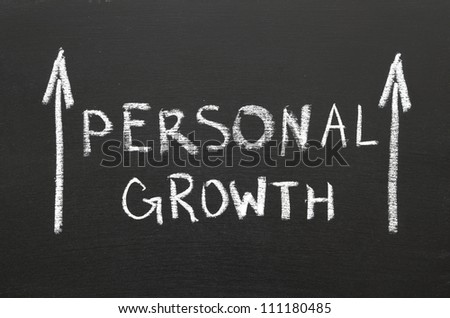 Personal growth phrase handwritten on the chalkboard with rising arrows