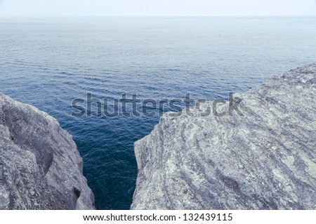 two white weathered cliffs above wide ocean