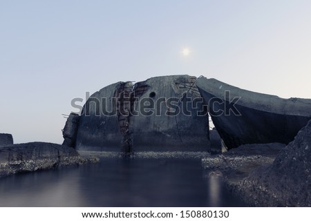 twilight scenery with abandoned ruins in water and rising moon