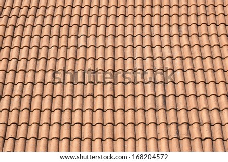 red tile roof by bright sunny day