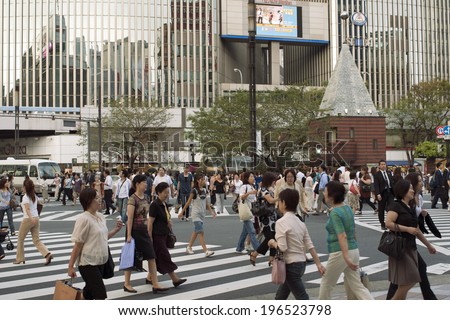 TOKYO, JAPAN - SEPTEMBER 20:many people cross huge road junction  by well organized zebra pathways in Ginza area on September 20, 2008 in Tokyo,Japan.