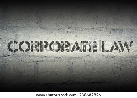 corporate law stencil print on the grunge white brick wall