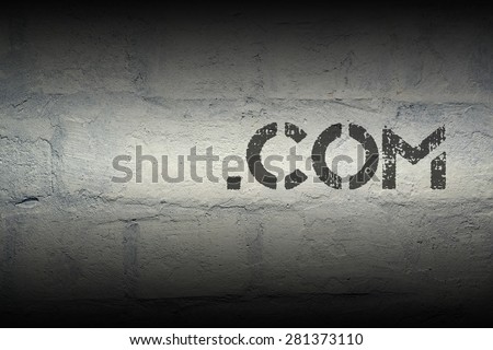 dot com stencil print on the grunge white brick wall